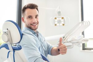 Man smiling and holding thumbs up